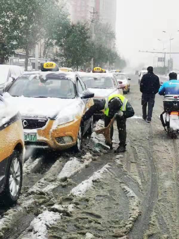 的哥的姐感慨说：换电站铲冰扫雪换电忙