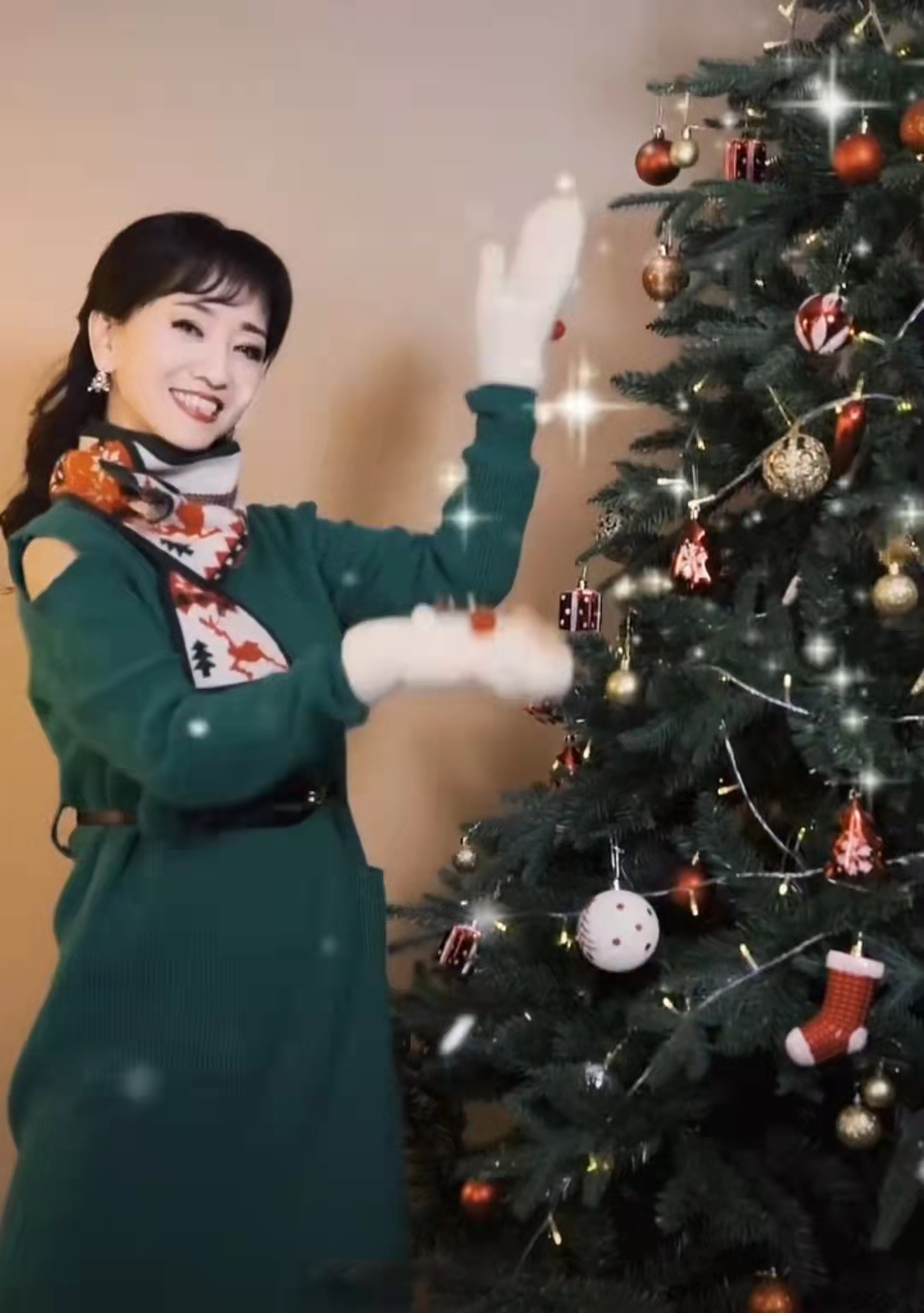 马苏也选择了一条绿色长裙,吊带款式更能凸显她的好身材,她站在圣诞树