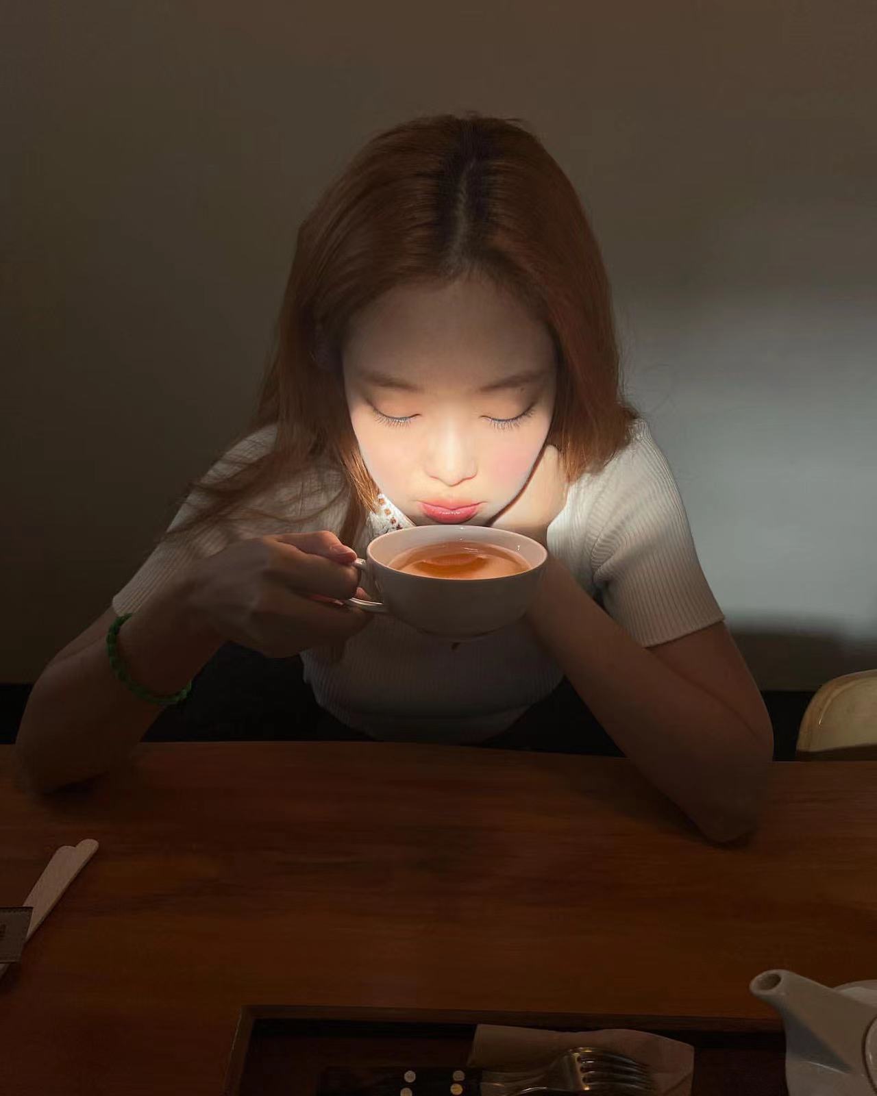 红润的腮红，Jennie悠闲品茶，幽暗中晒下一缕阳光，氛围很是优雅
