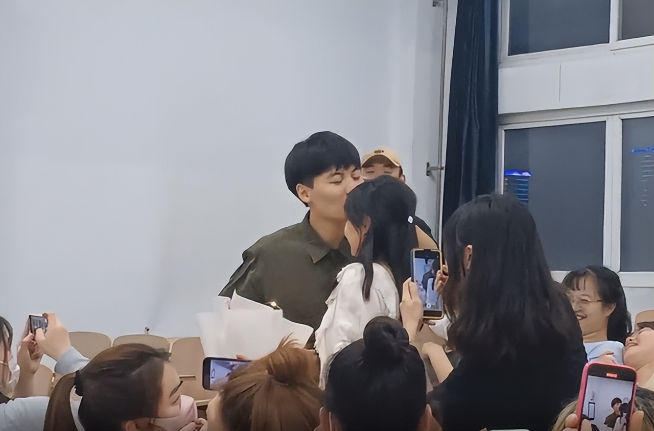 大学生手捧鲜花向心仪女生表白，引众人围观，温柔亲吻获网友点赞